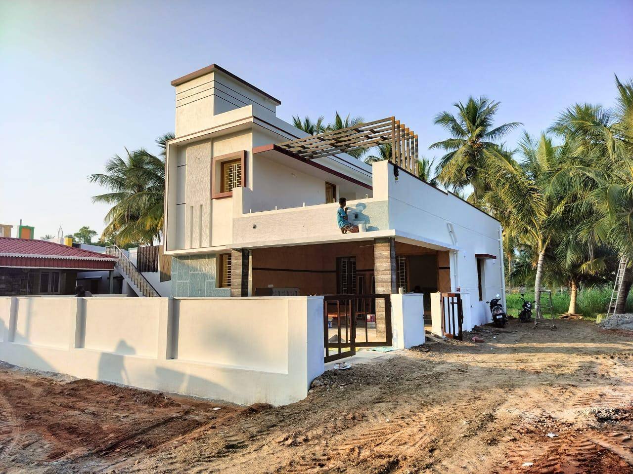 Beautiful villa-style house with palm tree landscaping by AK Constructions